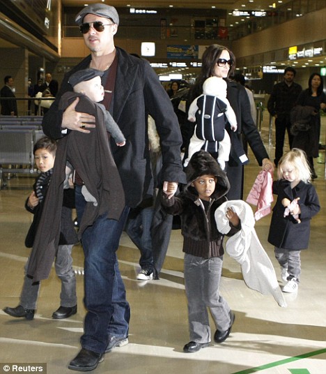 Brad Pitt and Angelina Jolie arrive with their children at Narita airport